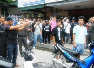 Angkul Srihanan shows police and onlookers how he allegedly murdered two men on the streets of Pattaya.